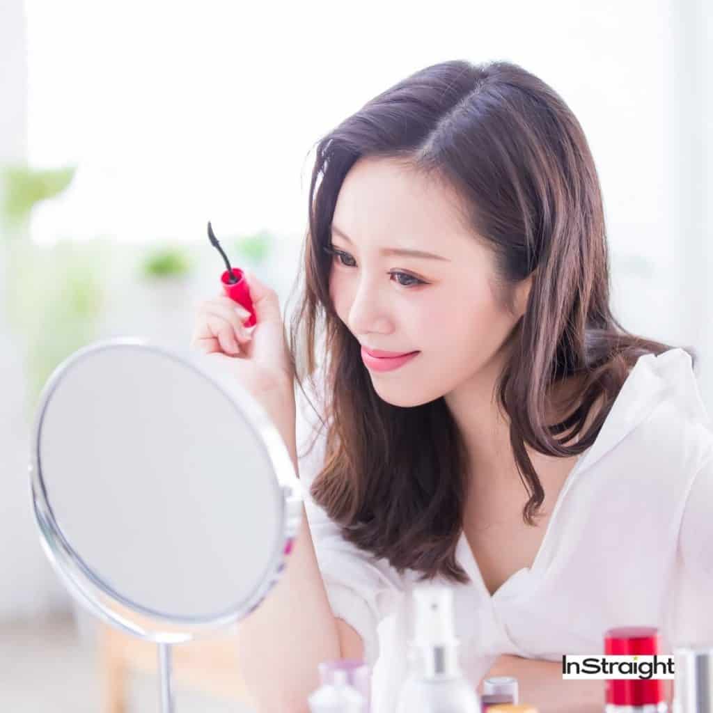 lady putting her mascara